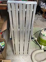 Platform ladder folded showing ribbed aluminum planks