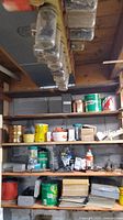 Shelves with multiple jars of hardware, hole saws holders overhead
