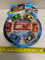 Front view of sealed blister pack showing six cars and launcher