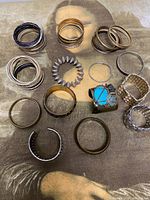 All bracelets laid out showing variety of styles and finishes