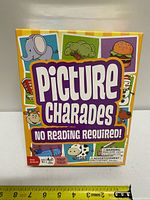 Front of Picture Charades sealed box with ruler for scale
