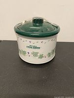 Front view of Rival Little Dipper stoneware server showing ivy pattern, green lid and logo