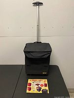 Front view of black Smart Cart with handle extended and lid in place