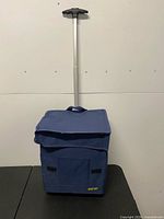 Front view of blue Smart Cart rolling tote with handle extended