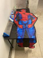 Full kite laid on table showing character design and attached lines