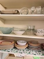 shelved dinner plates, bowls, glassware and bakeware