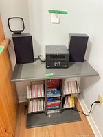 overall lot showing stereo, speakers, shelf and CDs
