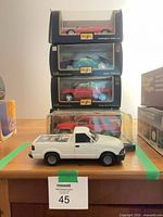 Stack of three boxed Maisto cars, boxed Majorette SUV, loose white pickup