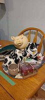 Overview of pig, cow items, placemats and planter on table