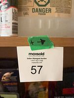 Shelf with lot tag, shows chemical jug and aerosol can
