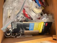 Drawer view showing 3M sandpaper pack, wall plate, zip bag of small parts