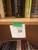 Upper shelf showing multiple hardcover books with dust jackets