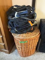 Wicker hamper with bags stacked on lid