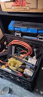 Crate with extension cord, garden tools, view of toolbox above