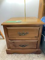 Front view of one nightstand showing drawers and hardware