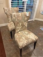 Both accent chairs showing full form and upholstery pattern