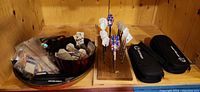 Overview of darts on wooden stand, bags of parts, two cases