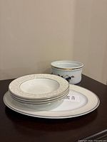 Group shot showing plate, stack of four bowls, and ribbed fruit bowl