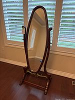Full view of oval cheval mirror on stand