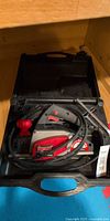 Planer inside black carrying case with cable and accessories
