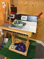 Full view showing analyzer on wood stand with clamp, graph paper and accessories