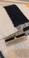 Close-up of towel with navy stripe and Hudson's Bay tag