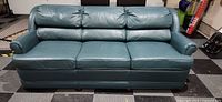Front view of Ethan Allen teal leather three-cushion sofa