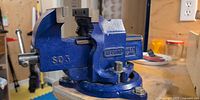 Overall view of Record SQ3 blue bench vise on workbench