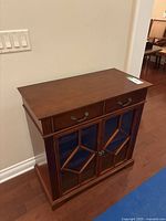 Front view showing drawers and glass doors