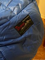 Brand label on blue Thaw down sleeping bag