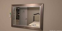 Full view of rectangular wall mirror mounted on wall