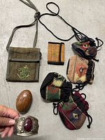 Full lot showing bag, wallet, three pouches, wood box, cuff bracelet