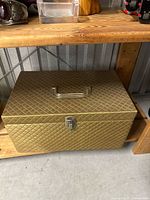 Closed gold quilted sewing caddy on shelf