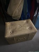 Angled view of vinyl ottoman chest showing side panel and lid