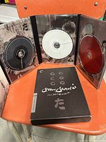 Slipcase front and opened tri-fold showing three discs and booklet