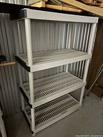 Front angled view of white 4-tier plastic shelf