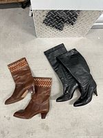 Both pairs of boots laid flat showing overall design and condition