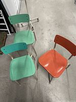 Three small vintage school chairs two green one salmon