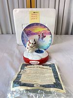 Full view of figurine with plate, base, COA and Styrofoam