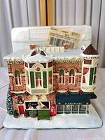 Front view of lighted Hawthorne Village Coca-Cola hardware store building