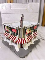 Front corner view of lighted diner building with Coca-Cola signs