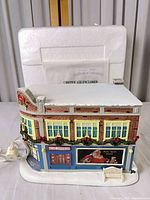 Front view of illuminated Jewelers building with cord attached