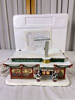 Front view of lighted florist building with power cord and packaging