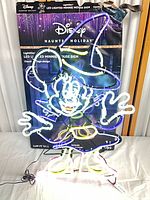 Full view of illuminated LED Minnie Mouse sign with box behind