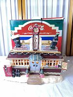Front view of lighted Coca-Cola diner with original box