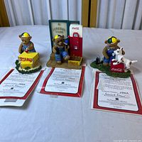 Overview of three Coca-Cola bear figurines with certificates