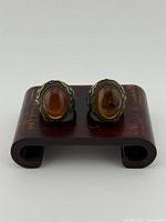 Front view of both rings on stand highlighting amber cabochons