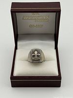 Ring in presentation box showing face design