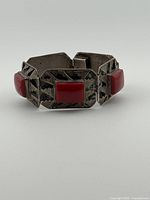 Front angle view showing three silver links with red cabochons