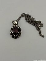 Front view of sterling silver garnet pendant on chain